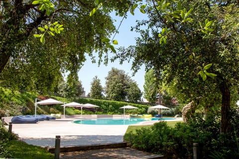 Seasonal outdoor pool, open 10:00 AM to 6:30 PM, pool umbrellas