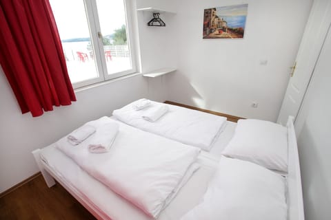 Apartment, 2 Bedrooms, Sea View | Iron/ironing board, free cribs/infant beds, free WiFi, bed sheets