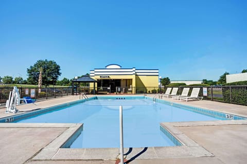 Seasonal outdoor pool, open 11:00 AM to 10:00 PM, pool umbrellas