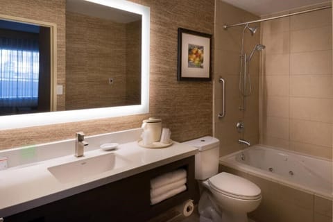 Suite, 1 King Bed, Jetted Tub | Bathroom | Hair dryer, towels, soap, shampoo