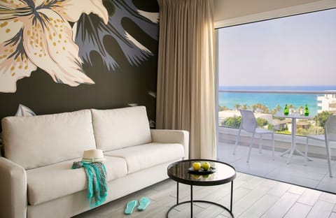 Junior Suite - Limited Sea View | Living area | 32-inch flat-screen TV with satellite channels, TV