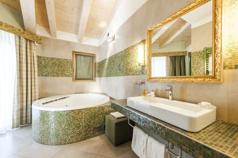 Deluxe Suite, Jetted Tub | Bathroom | Hair dryer, bathrobes, towels, soap