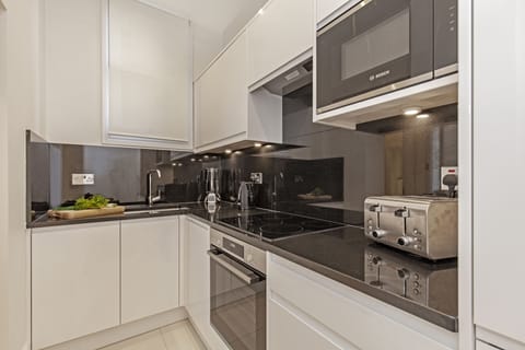 Executive One Bedroom Apartment | Private kitchen | Full-size fridge, microwave, oven, stovetop