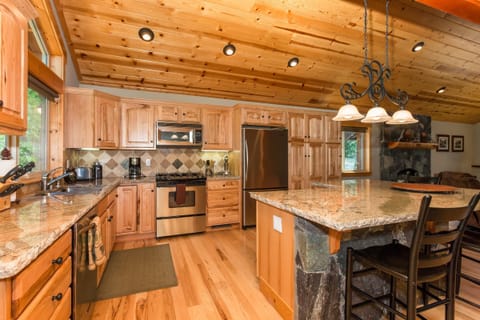 Spacious kitchen with granite counter tops and stainless steel appliances