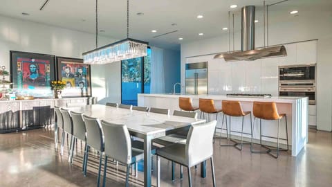 Bright dining area with chic lighting and a modern open kitchen.