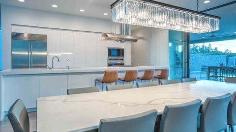 Bright modern kitchen with seamless indoor-outdoor dining.