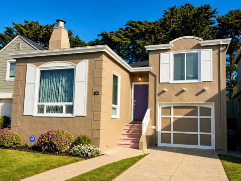 Charming home exterior with a private driveway, garage, and welcoming entry - perfect for a comfortable stay.