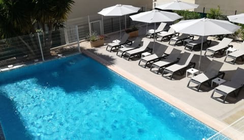 Seasonal outdoor pool, open 9:00 AM to 8:00 PM, pool umbrellas