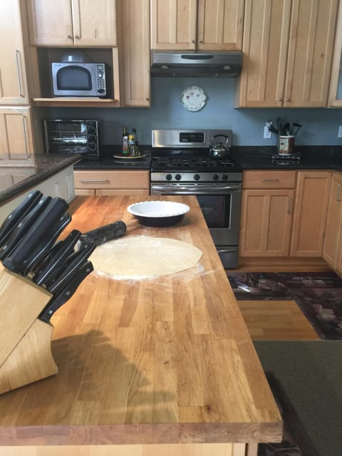 Rolling a Pie Crust on the Kitchen Butcher Block Island Fun to Cook Together