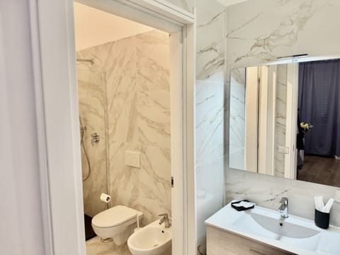 Designer toiletries, hair dryer, slippers, bidet