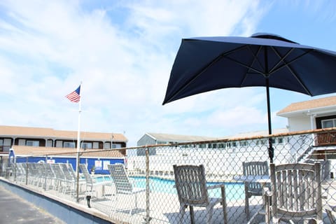 Seasonal outdoor pool, open 9 AM to 9:30 PM, pool umbrellas