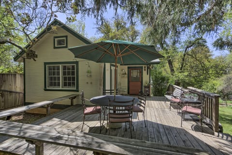 Umbrella-shaded seating for six, with additional bench seating
