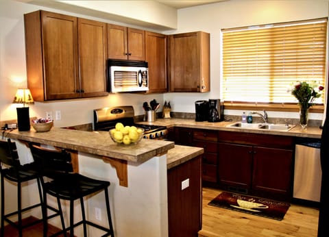 Kitchen with crockpot, coffee and Kuerig makers, dishes, flatware, platters, etc