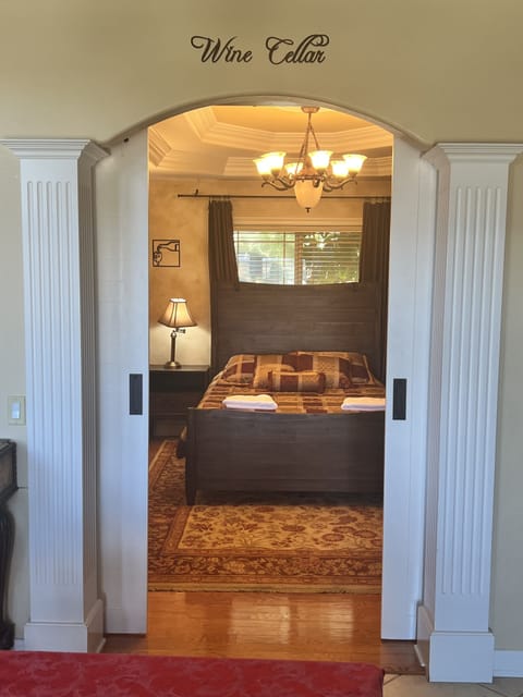 Library has a queen size bed and hanging barn doors for privacy.