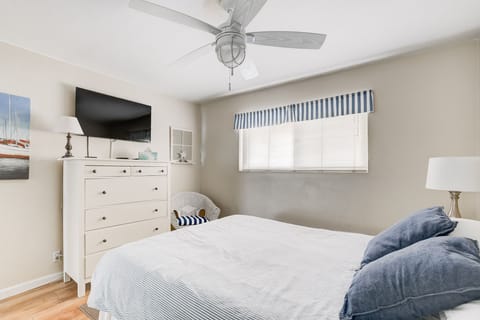 Bedroom TV and dresser. Full-size closet with mirror doors.