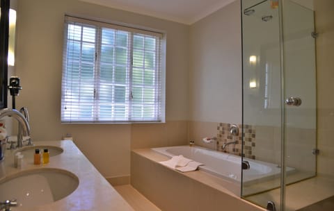 Suite, 1 King Bed | Bathroom | Free toiletries, hair dryer, bathrobes, slippers