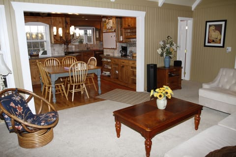 Living Room view toward kitchen dining and powder room.
