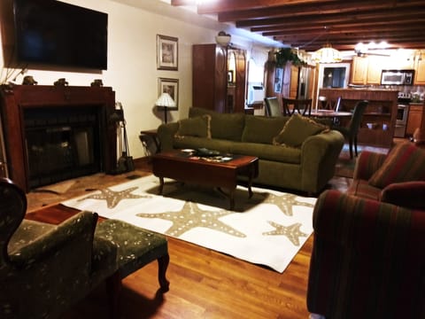 Cozy living area with electric fireplace and filled with antiques.