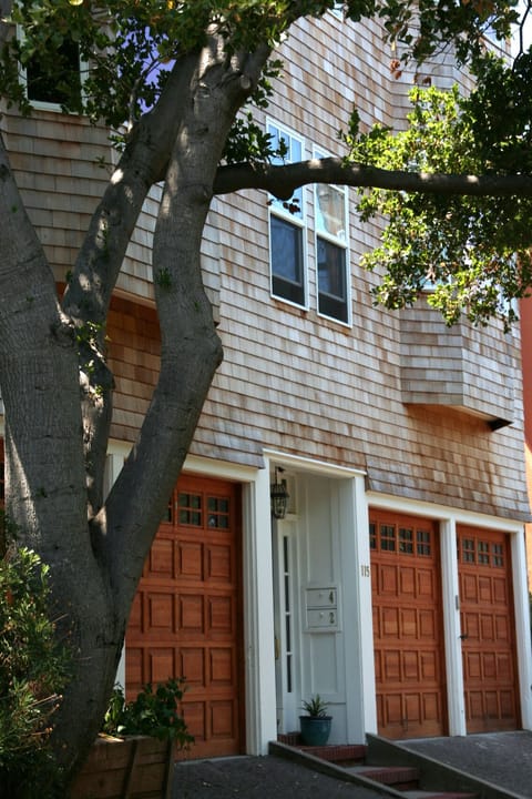 Front entrance, with parking in front of far-right garage, plus a parking pass.