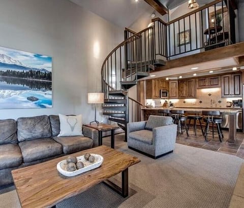 Living Room with spiral staircase to loft.