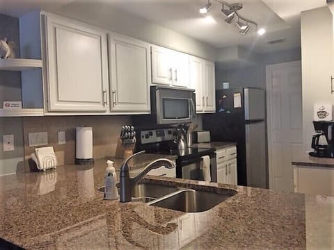 Updated kitchen with plenty of utensils and cookware