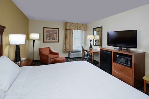 Premium bedding, desk, laptop workspace, blackout drapes