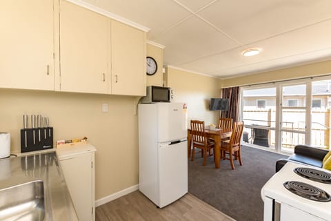 Waitangi Beach Bach 30A | Private kitchen | Full-size fridge, microwave, oven, stovetop