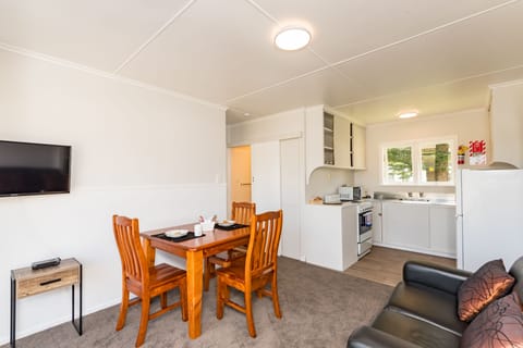 Waitangi Beach Bach 30B | Living area | Flat-screen TV