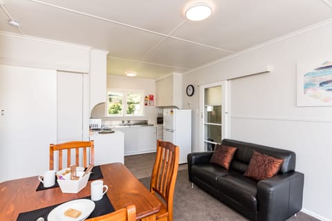 Waitangi Beach Bach 30B | Living area | Flat-screen TV