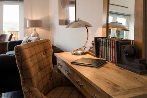 Byre - desk with tartan armchair in sitting room