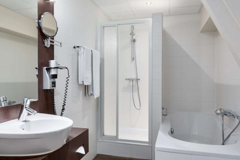 Deep soaking tub, rainfall showerhead, eco-friendly toiletries