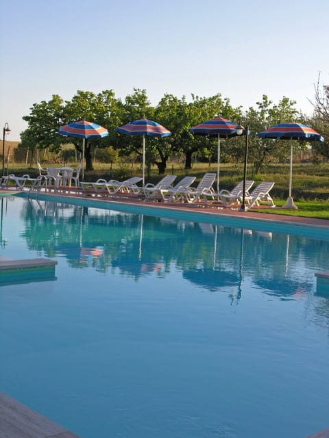 Outdoor pool, open 8 AM to 7 PM, pool umbrellas, sun loungers