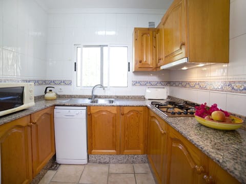 Countertop, Kitchen, Cabinetry, Property, Room, Furniture, Yellow, Building, House, Floor