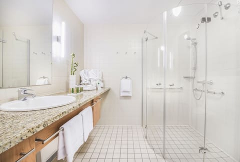 Shower, designer toiletries, hair dryer, towels