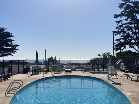 Outdoor pool, open 9:00 AM to 9:00 PM, pool umbrellas