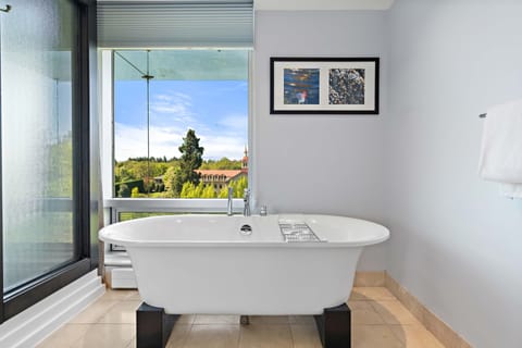 Suite, 1 Bedroom, Corner | Bathroom | Combined shower/tub, eco-friendly toiletries, hair dryer, bathrobes