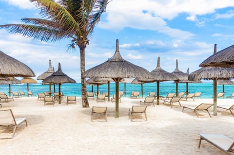 On the beach, white sand, sun loungers, beach umbrellas