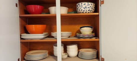Glasses, mixing bowls, coffee mugs, paper filter coffee maker.