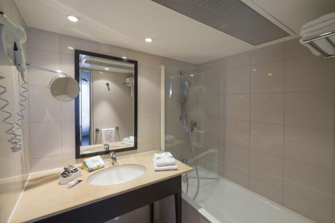 Bathtub, eco-friendly toiletries, hair dryer, towels