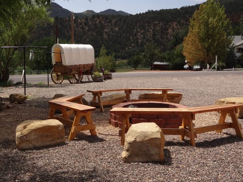 Fire pit with our Amish covered wagon in the background.