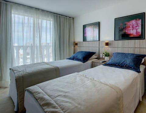 Deluxe Double or Twin Room, Sea View | Minibar, in-room safe, desk, blackout drapes