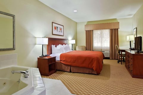 Suite, 1 King Bed, Non Smoking, Jetted Tub | Premium bedding, desk, blackout drapes, iron/ironing board