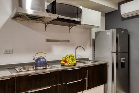 Two-Bedroom Apartment with Balcony | Private kitchen | Full-size fridge, microwave, stovetop, cookware/dishes/utensils