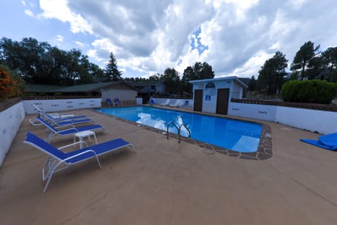 Seasonal outdoor pool, open 9:00 AM to 10:00 PM, pool umbrellas