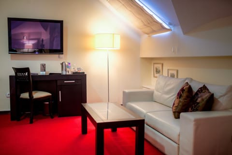 Junior Suite | Living area | 55-inch LCD TV with cable channels, TV