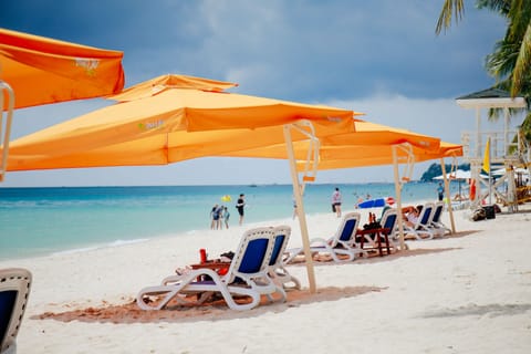 On the beach, white sand, beach umbrellas, beach towels