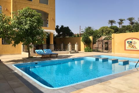 Outdoor pool, open 6:00 AM to 6:00 PM, pool umbrellas, sun loungers