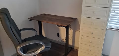 New adjustable sit/stand desk with ergonomic chair for working from home