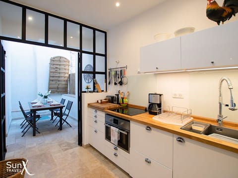 Kitchen leading onto open terrace outside