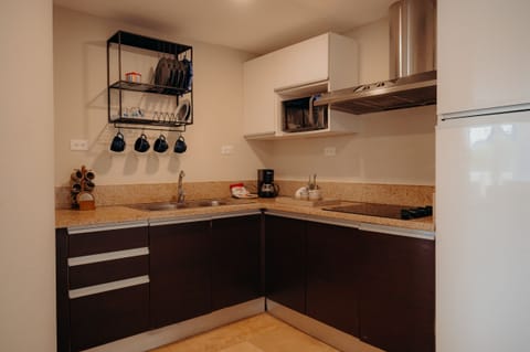 Deluxe Suite, 2 Bedrooms | Private kitchen | Fridge, microwave, coffee/tea maker, cookware/dishes/utensils